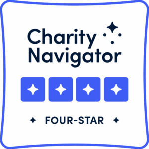 Charity Navigator four-star rating badge with four blue stars and the words Charity Navigator and FOUR-STAR on a white background.