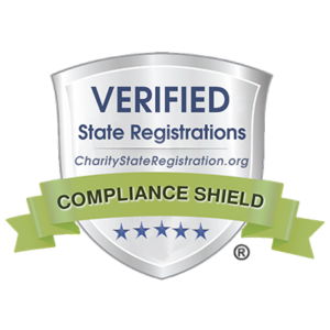 A silver shield with text Verified State Registrations and CharityStateRegistration.org, featuring a green ribbon that says Compliance Shield and five blue stars at the bottom.